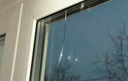 Double pane window crack due to mechanical damage